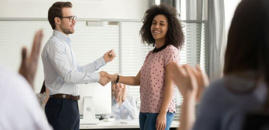 employee recognition ideas woman hand shake in the office