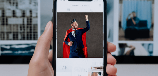 social media shout out of a man in a cape on the phone screen