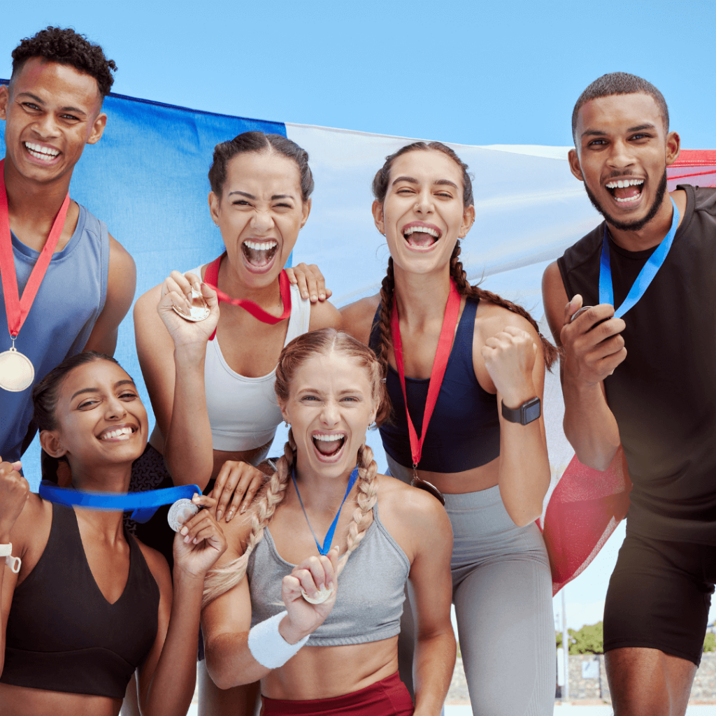 office Olympics team with medals and flags in sportswear