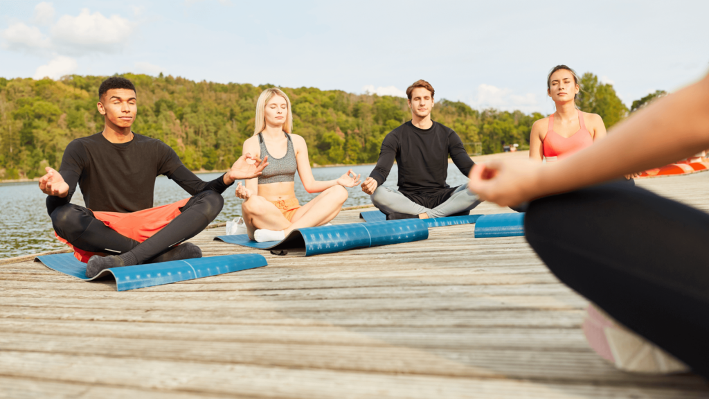 wellness retreat sitting on a pier in the lotus position