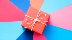 Sales Incentive Programs with a pink present on a swirled background